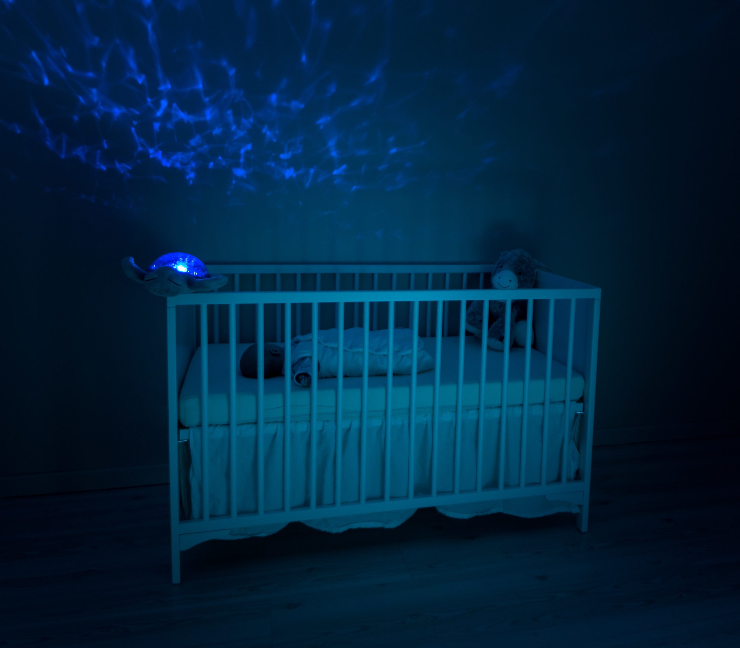 Baby in crib at night (via Unsplash)